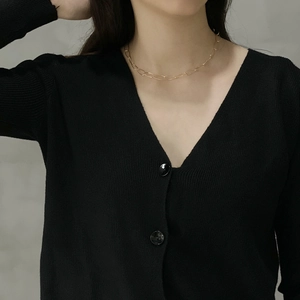 Close-up of minimalist gold thin chain necklace with oval links on a model neck