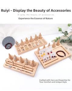 Macro shot of natural beechwood cone ring holder and multi-slot wooden jewelry display tray