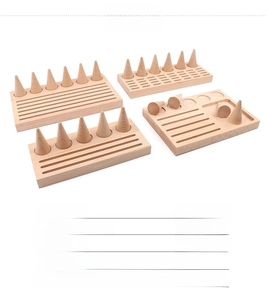Detailed view of beech wood cone ring stands and earring slots for jewelry display