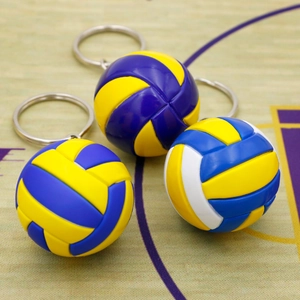 Detailed view of three mini volleyball keychains with realistic texture on a court backdrop
