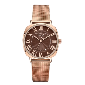 Detail of rose gold mesh band watch with brown sunburst dial and Roman numerals