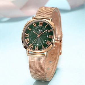 Rose gold mesh strap watch with green sunburst dial and Roman numeral hour markers