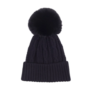 Close-up of thick cable knit pattern and soft faux fur pom-pom on the black beanie hat