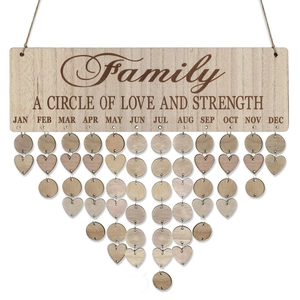 Close-up of wooden family birthday calendar with hanging heart and circle tags