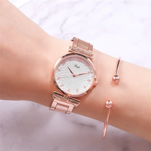 Close-up of rose gold watch dial with sunray texture and matching spherical bracelet