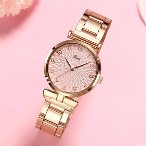 Elegant rose gold women's quartz watch with pink embossed dial and bow bracelet detail
