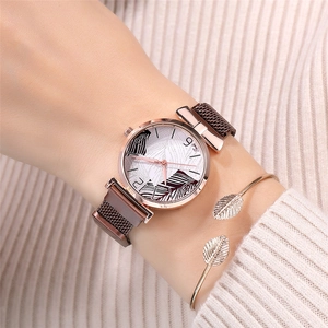 Close-up of rose gold magnet watch with leaf dial and matching metal bracelet on wrist