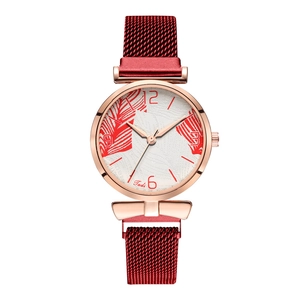 Detail of elegant Tadi quartz watch with rose gold case and red magnetic mesh strap