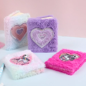 Detail view of colorful plush unicorn notebooks with sequin heart embroidery