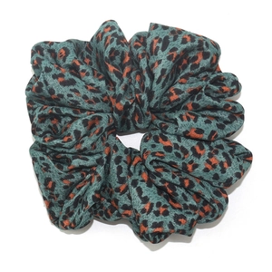 Oversized blue leopard print scrunchie made of soft fabric for bun hairstyles