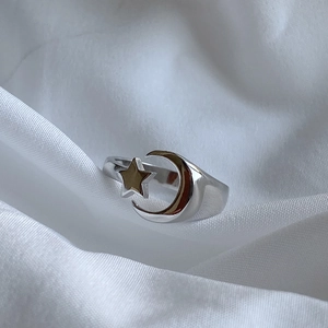 Detail of star and crescent moon minimalist design on polished 925 silver ring