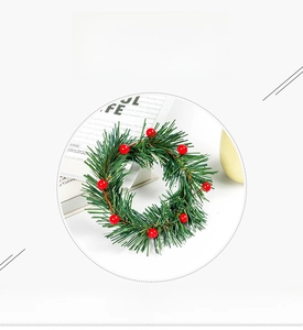 Close-up of artificial Christmas wreath with realistic red berries and green pine needles