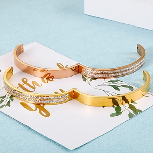 Fashionable hinge bangles in gold and rose gold with rows of sparkling zircon stones