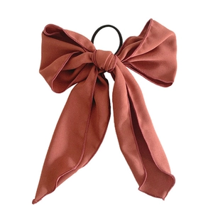 Elegant dusty rose bow hair scrunchie with long ribbons on white background