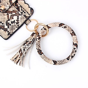 Macro view of snakeskin pattern PU leather card holder with tassel and gold keyring