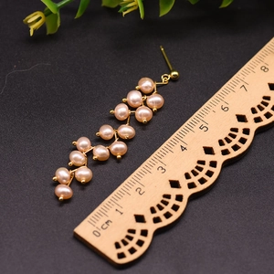 Detail view of 6cm long natural freshwater pearl drop earrings with 18k gold plating