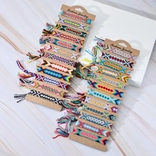 Macro detail of hand-woven friendship bracelets with colorful geometric patterns and tassels