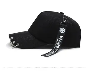 Detail of black baseball cap side with silver rings and WARGROUND tactical webbing strap