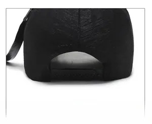 Close-up of adjustable plastic snapback strap on a black twill baseball cap back view