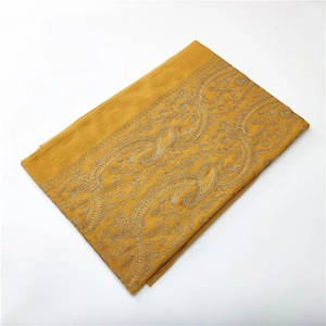 Close-up of yellow cashmere-like scarf showing intricate paisley embroidery detail