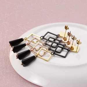 Geometric stainless steel drop earrings with faceted black pendants in four color finishes