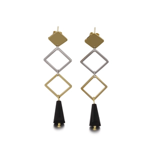 Modern geometric earrings with gold square studs and black pyramid pendants on white