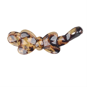 Detail of tortoise shell pattern on a resin bow banana hair clip for women hair styling