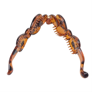 Macro shot of durable tortoiseshell resin banana hair clip with secure metal hinge