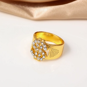 Detailed close-up of a golden hip-hop ring with sparkling dollar sign rhinestones