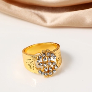 Close-up of golden dollar sign ring with sparkling rhinestones and textured metal details