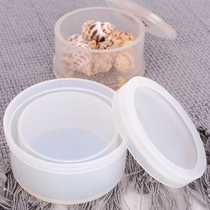 Close-up of a translucent white silicone storage jar mold with its lid placed beside it