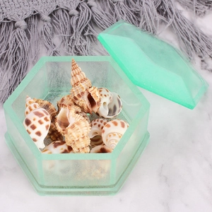Detailed view of a green resin hexagonal storage box with lid and glitter finish