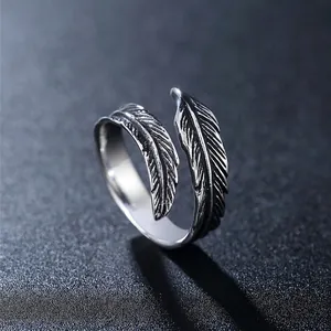 Vintage style stainless steel feather ring with detailed carvings and open wrap design
