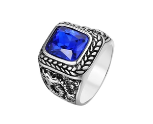 Macro view of blue gemstone ring featuring vintage dragon relief and wheat pattern