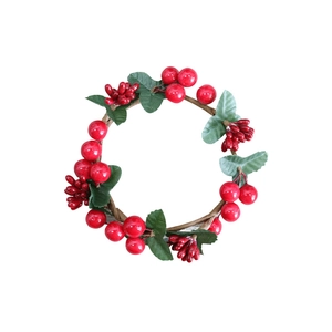 Christmas candle ring featuring vibrant red berries and green leaves on a woody base
