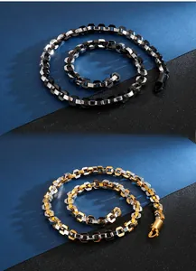 Close-up of geometric titanium steel chain with hexagon links in silver and gold dual-tone finish