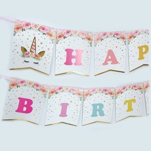 Detail of glitter unicorn happy birthday banner with gold foil and floral paper accents
