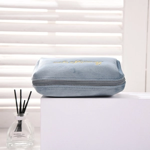 Detail of blue velvet makeup bag with gold Beautifully embroidery and zipper