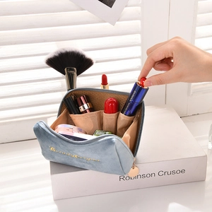 Detail view of the blue velvet makeup bag with soft lighting and interior compartments