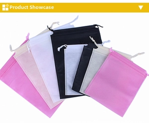 Detail of multi-color non-woven drawstring bags showing heat-pressed edges and textures
