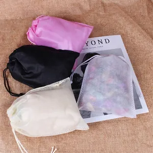 Non-woven drawstring storage bags in multi-color options on a linen texture background