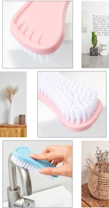 Close-up of foot-shaped cleaning brushes with stiff white bristles in pink and blue