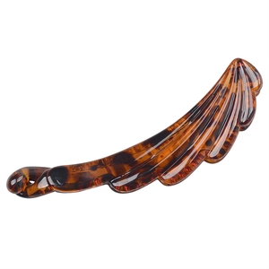 Detail of amber tortoiseshell banana hair clip with leaf shape and resin texture