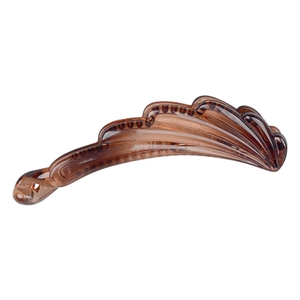 Detailed view of the wavy texture on a translucent brown resin banana hair clip