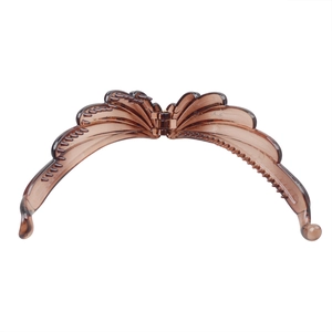 Detail view of a translucent brown banana hair clip with a stylish wing design