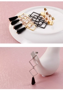Detailed display of geometric square metal earrings with black teardrop charms in four colors