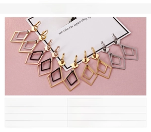 Macro shot of geometric stainless steel hoop earrings in various metallic finishes