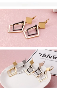 Detail view of geometric diamond-shaped drop earrings in gold, silver, black and rose gold