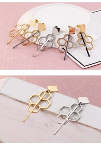Detailed view of geometric tassel earrings in gold, silver, and rose gold finishes