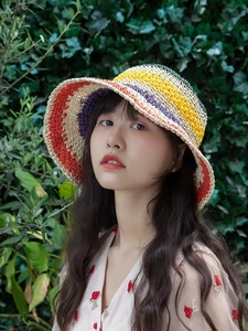 Detail of colorful striped crochet sun hat with a wavy brim for beach vacations